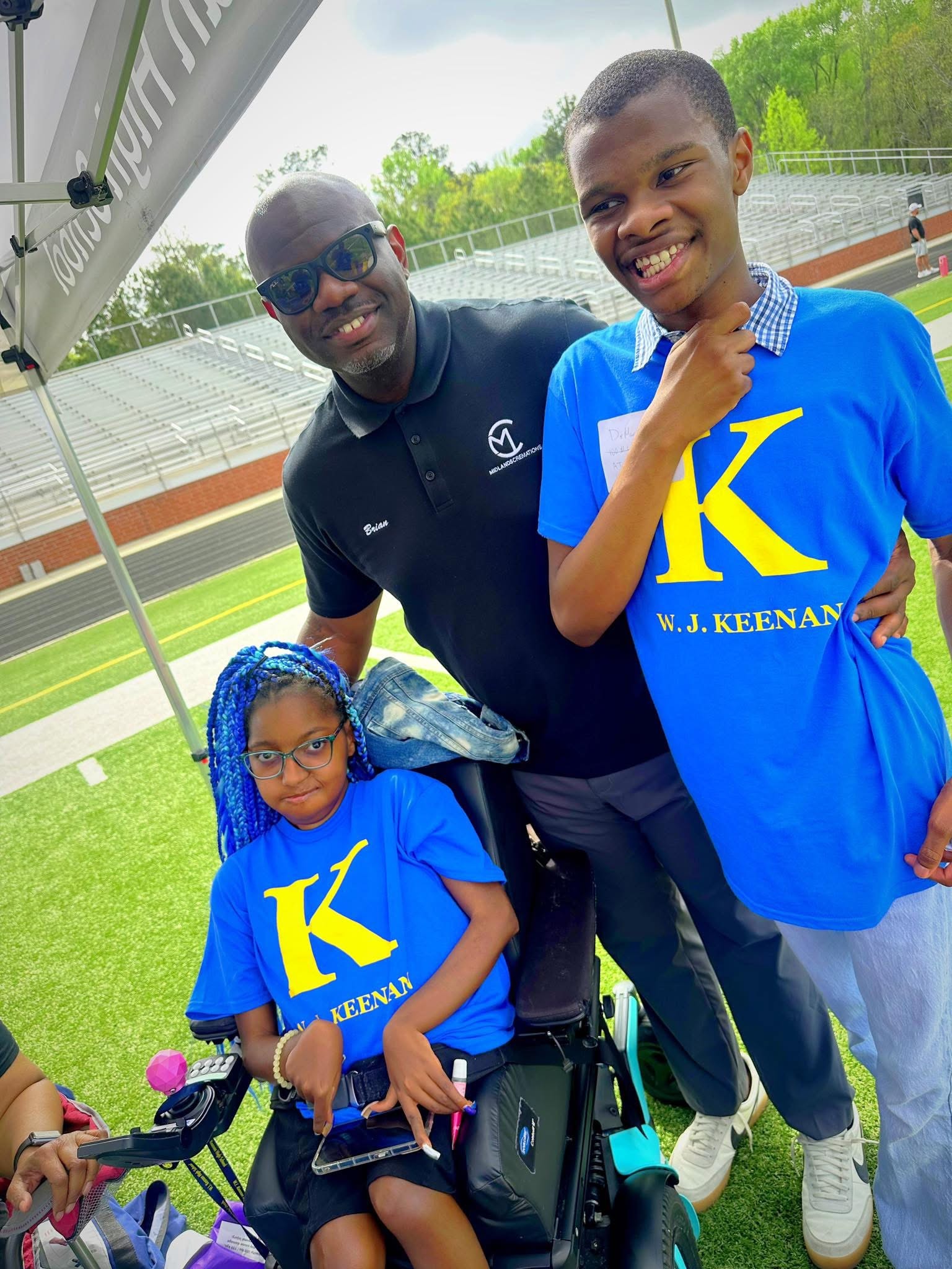 Brian Myers with W.J. Keenan students at a track and field event